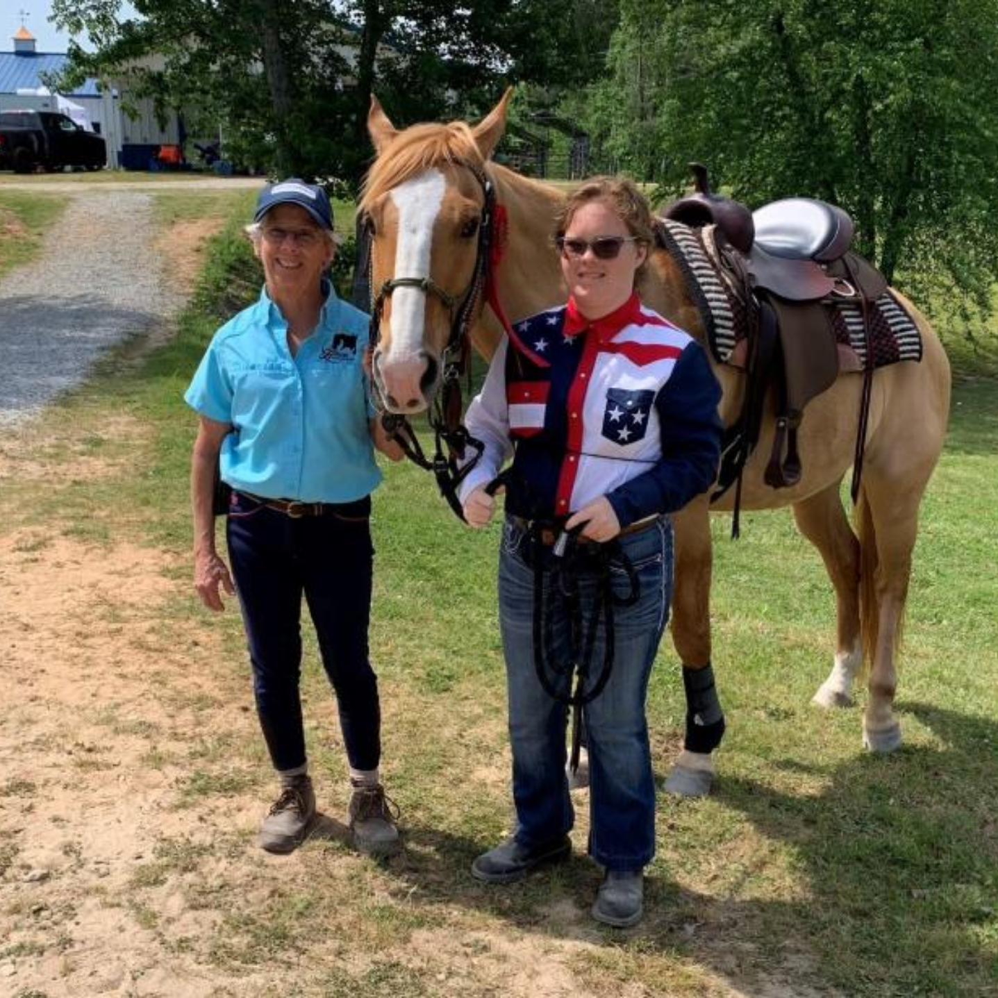 Photo of Heroes on Horseback staff member and rider both posing with horse outdoors