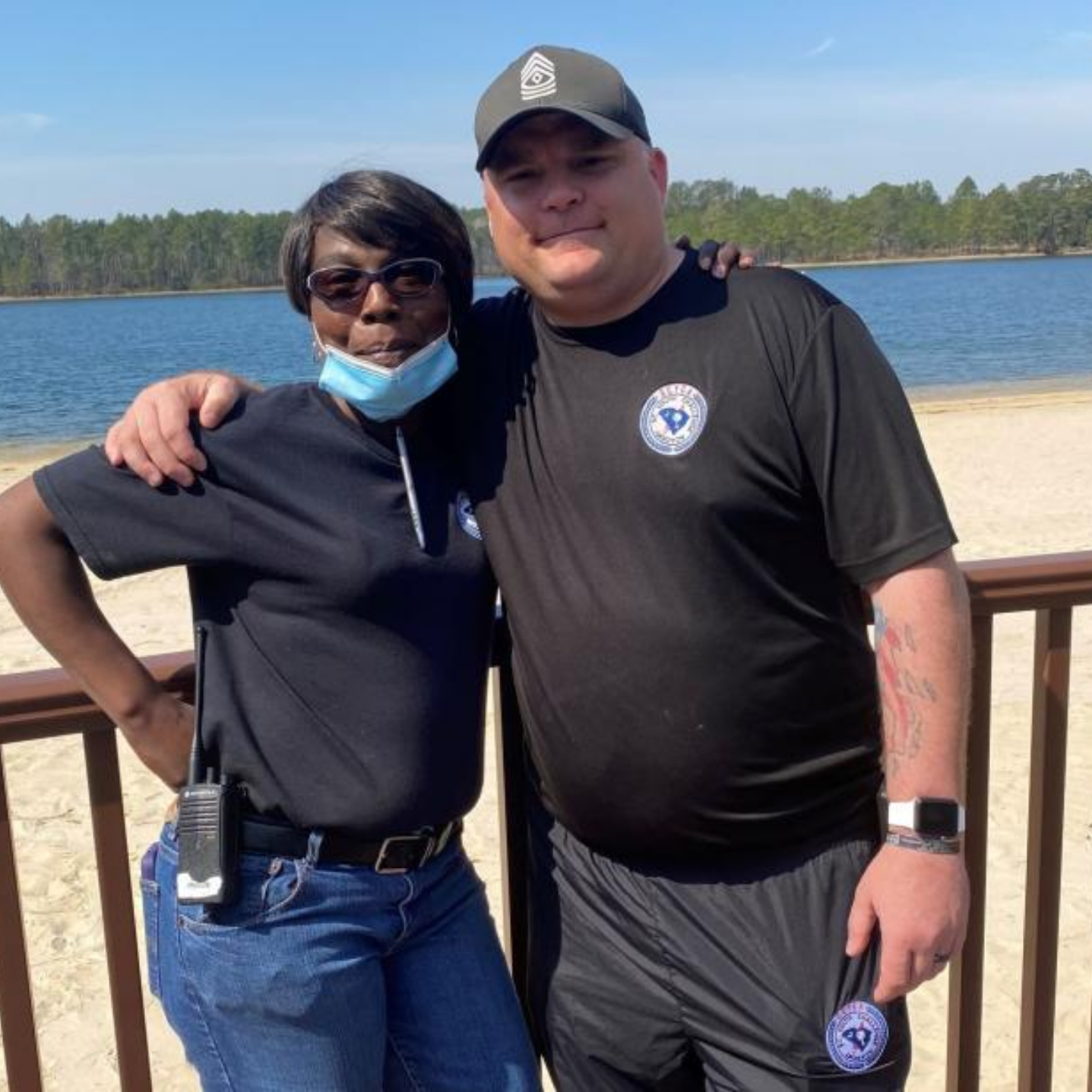 Two South Carolina Youth Challenge employees posing for a photo together outside