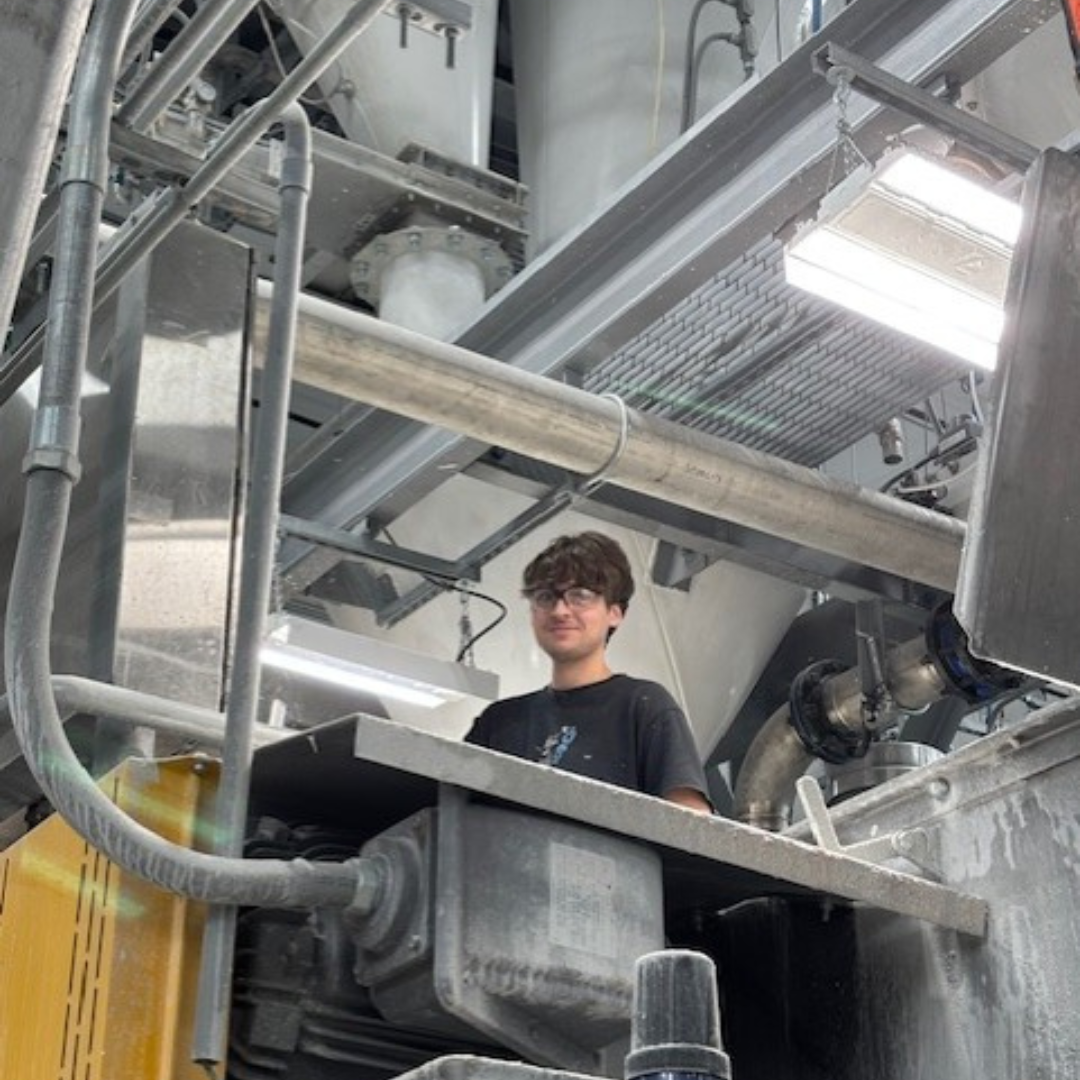 A man looks down from above, working in his office