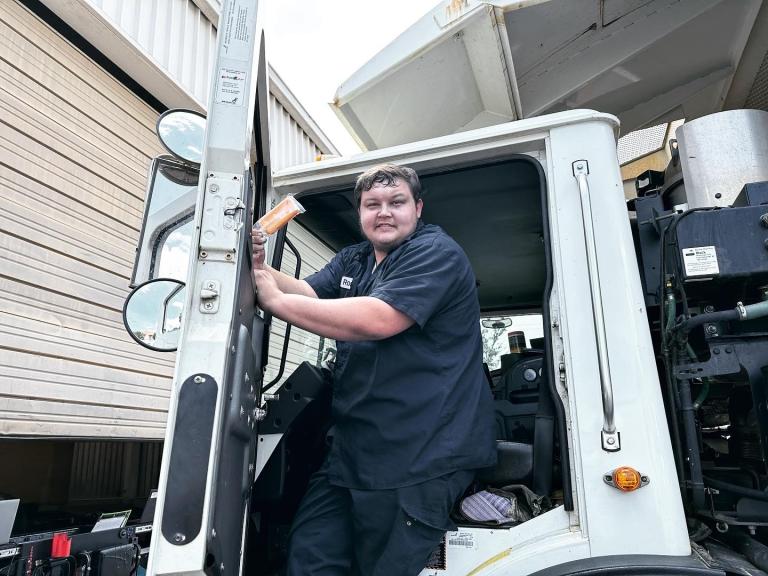 Photo of Shealy's Truck Center staff member exiting driver's seat of large truck.