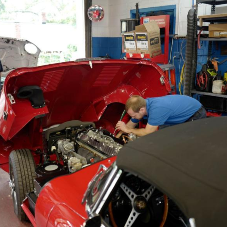 Photo of Import Specialties of Columbia LLC staff member working under the hood of a car